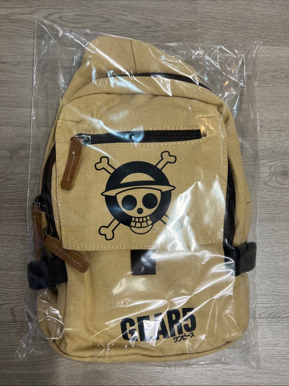 One Piece Men's Canvas Sling Bag in Tan with one piece emblem.